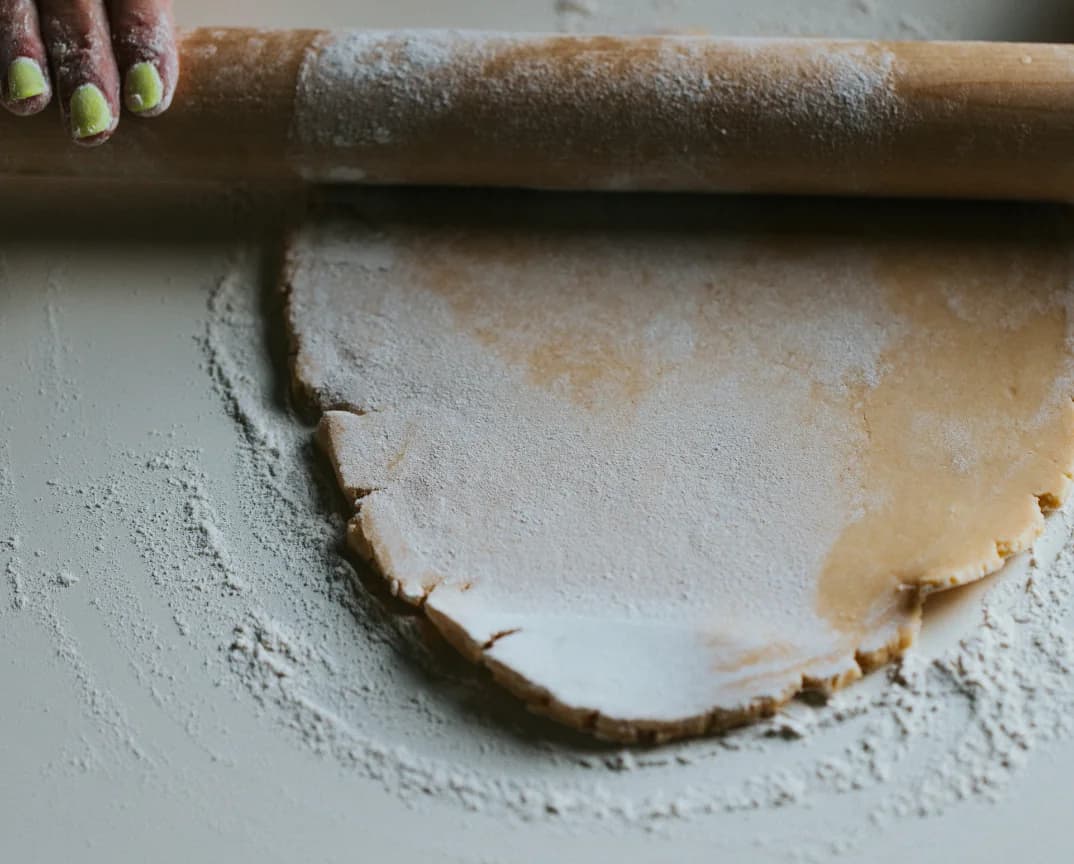 Dough being shaped on a floured surface